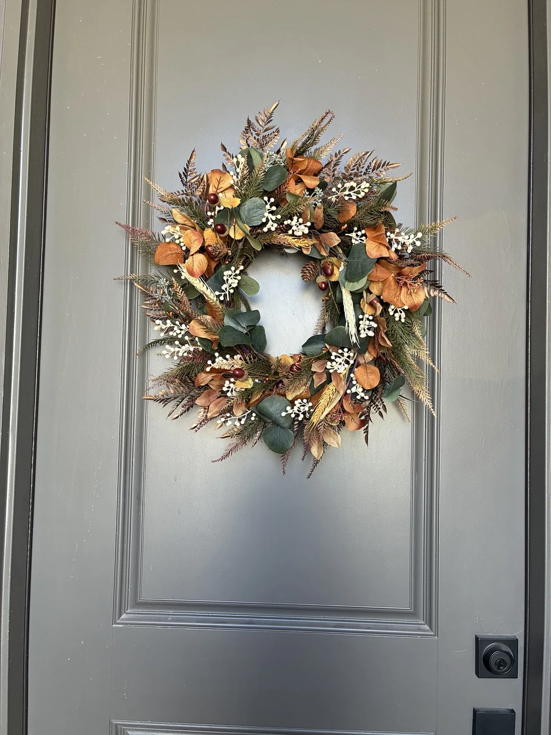 Handcrafted WoodBee Floral wreath on a front door