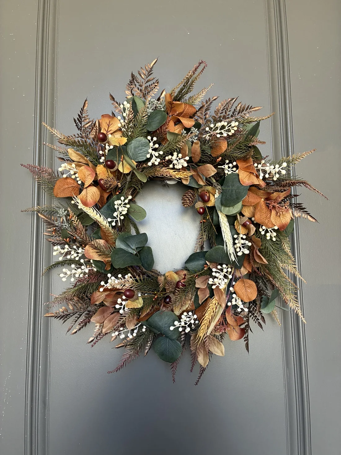 WoodBee Floral wreath displayed on a charcoal front door